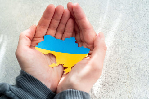 hands holding ukranian flag